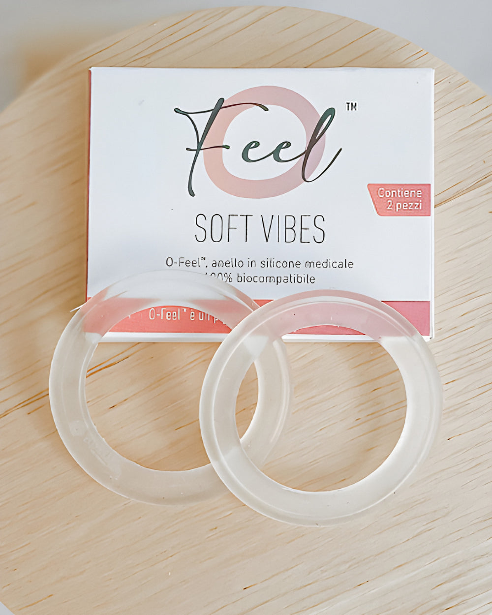 Silverette O-Feel Soft Vibes box and two clear silicone rings on a round wooden board